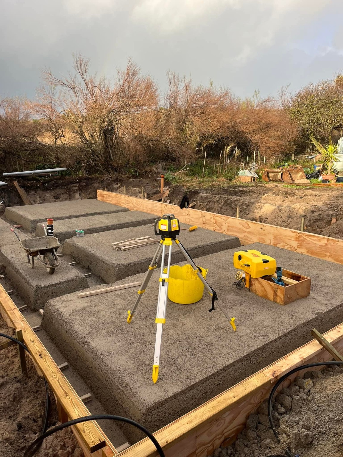 Groundwork foundation pads and laser level on site